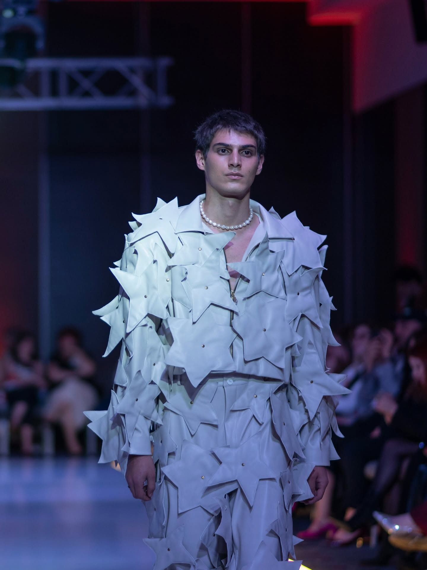 Model in a silver metallic outfit walking the Georgia Global Fashion Week runway